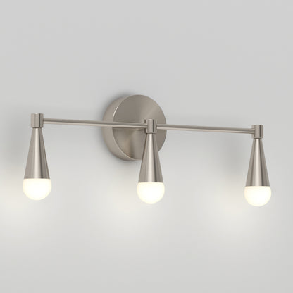 The Artika Wayden LED mid-century bathroom vanity light features three cone-shaped metal holders with round frosted bulbs, all mounted on a circular base against a light gray wall.