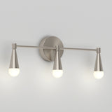 Three-light wall sconce with a brushed nickel finish, featuring conical shades and frosted globe bulbs, mounted on a circular backplate against a plain light-colored wall.