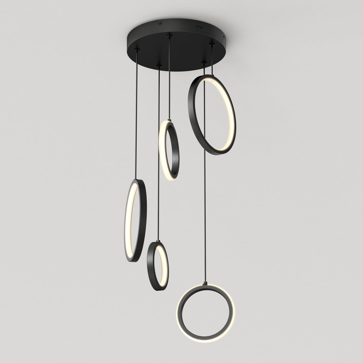 The Artika Elmo 5-light LED pendant features five circular LED rings of varying sizes, suspended at different lengths from a round black base, offering a modern lighting solution with adjustable color temperatures.