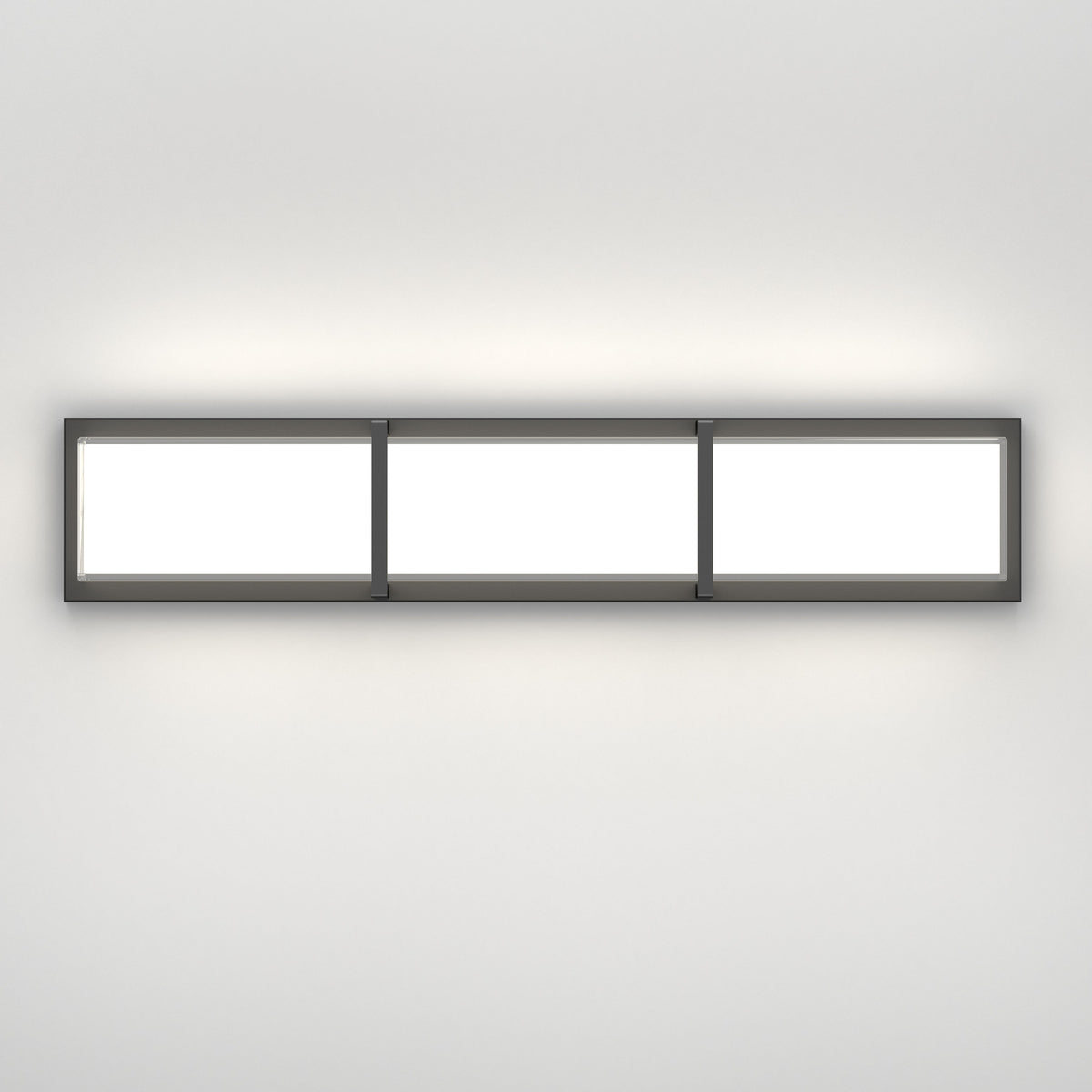 A modern rectangular wall light fixture with three illuminated panels, mounted horizontally on a plain white wall, emitting a soft glow.