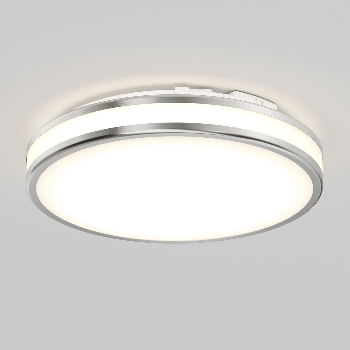 The Artika Hemisphere 15 in. LED flush mount light features a modern design with a metallic rim and frosted diffuser, offering 5 CCT options for perfect bathroom lighting and a soft, even glow when mounted on a white ceiling.