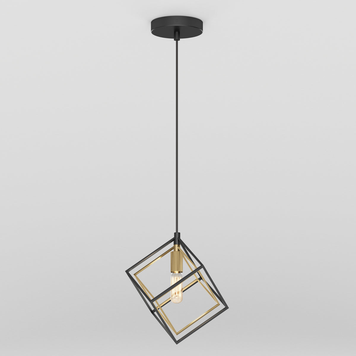 The Artika Imperium Single pendant light features a black and gold geometric metal cube frame, suspended by a black cord and ceiling mount, with an exposed bulb for a modern touch.