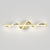 A modern wall light fixture with a gold base and two intertwined, wavy LED light bars extending horizontally, mounted on a plain light gray wall.
