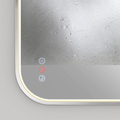A close-up of the Artika Royce dimmable LED mirror 3 CCT shows its fogged upper section, illuminated border, and three touch-sensitive icons in the bottom left corner—one lit red, two blue.
