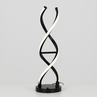 The Artika Swirl LED table lamp features two intertwined, spiral-shaped dimmable LED strips resembling a DNA double helix, set on a black and chrome base against a plain gray background.