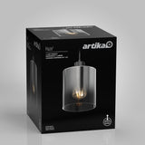 A black Artika product box displays a Haze light pendant with a clear glass shade. The front shows an image of the pendant with an exposed bulb, and product details appear in white text.