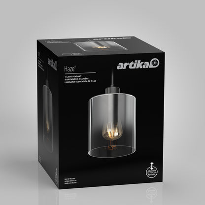 A black Artika box showcases the Haze pendant light glass, featuring a clear cylindrical shade and visible bulb. The product image and Artika logo stand out against the sleek background.