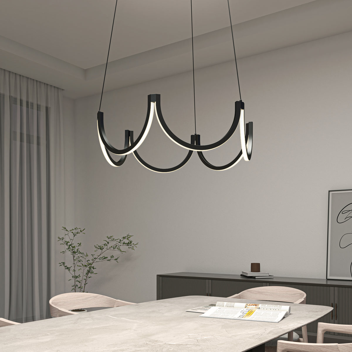 A modern dining room with a rectangular table, light chairs, minimalist decor, a potted plant, and a distinctive, curved, black-and-white LED chandelier hanging from the ceiling.