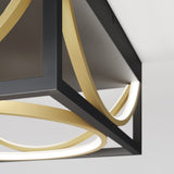 Close-up of a modern ceiling light fixture with a black square frame and curved gold and white LED light strips, set against a white ceiling and wall.