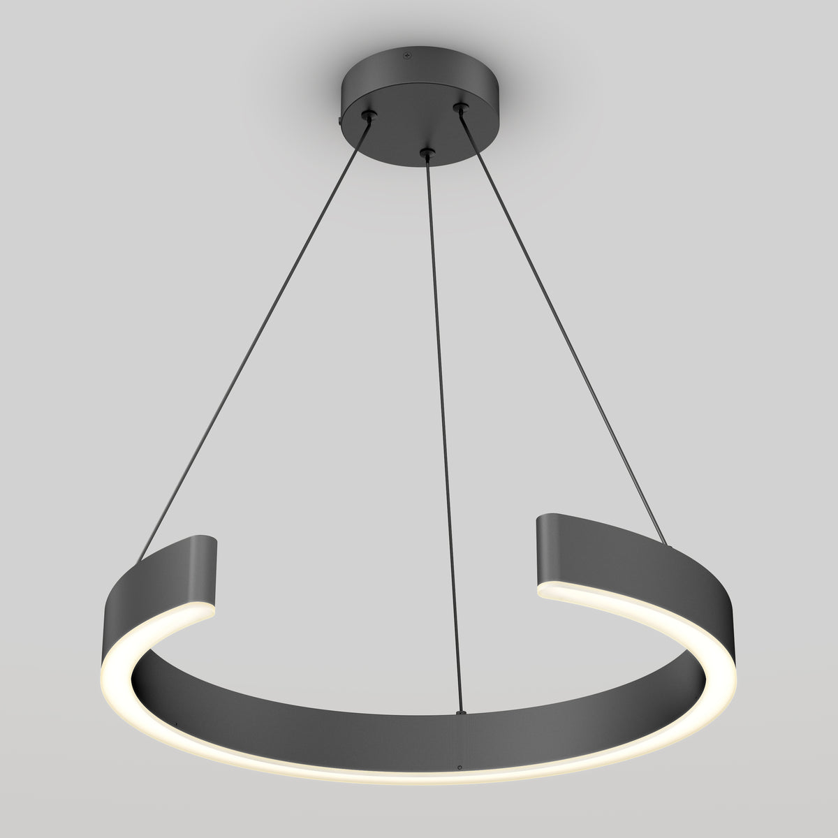A modern, circular pendant light with a matte black finish hangs from the ceiling by three thin cables. The light features a partial ring design with an integrated LED strip along the inner edge, creating a sleek, minimalist look.