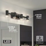 A modern matte black LED vanity light with four bubble glass diffusers is mounted above a bathroom mirror. Key features are labeled: bubble glass diffuser, matte black finish, integrated LED, and 3-year warranty.
