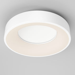 The Artika Aiden LED flush mount is a modern, circular white ceiling light with a minimalist design, mounted on a light gray ceiling. It provides evenly diffused lighting for a soft central glow.