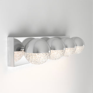 The Artika Carat 27-in Integrated LED Vanity Light Bar features four half-chrome, half-textured glass globes on a chrome base, creating a stylish and modern bathroom wall sconce.