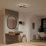 Modern hallway with wooden floating console, round mirror, hat and coat rack, two poufs, and a sculptural LED ceiling light. In the background, theres a dining area with a table and chairs by a large window.