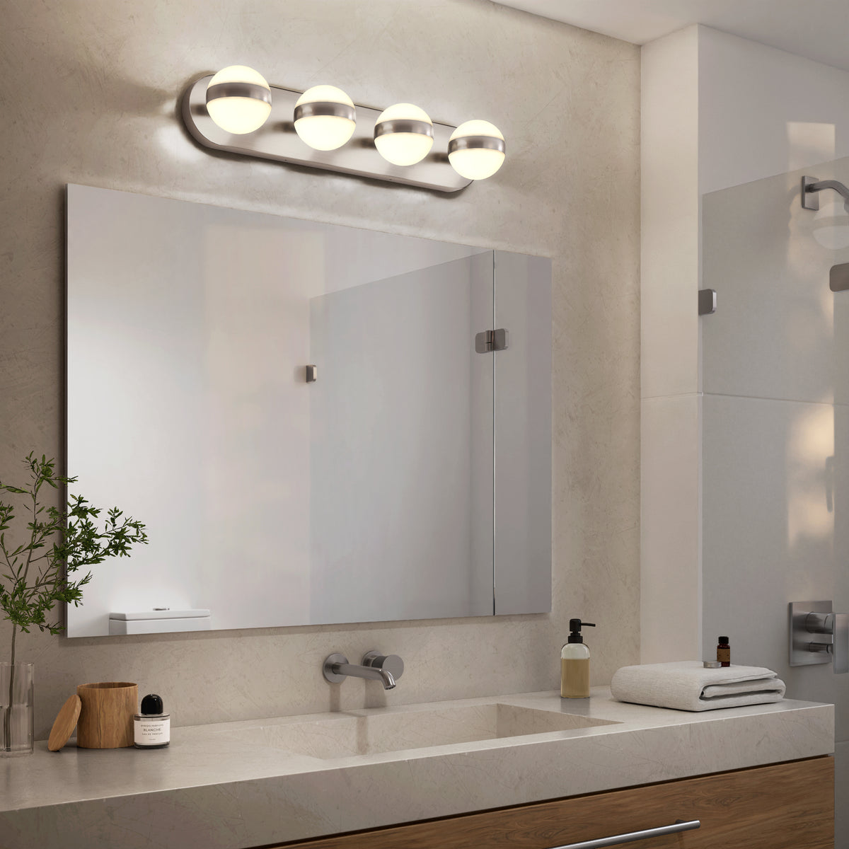 Modern bathroom with Artika Baldric LED vanity light (3 CCT), large mirror, sink, and tidy toiletries on the countertop.