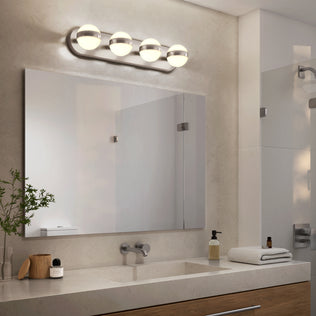 Modern bathroom with Artika Baldric LED vanity light (3 CCT), large mirror, sink, and tidy toiletries on the countertop.