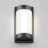 A modern wall-mounted outdoor light fixture with a rectangular frame and rounded edges, featuring a frosted white central panel that diffuses light, set against a plain gray background.