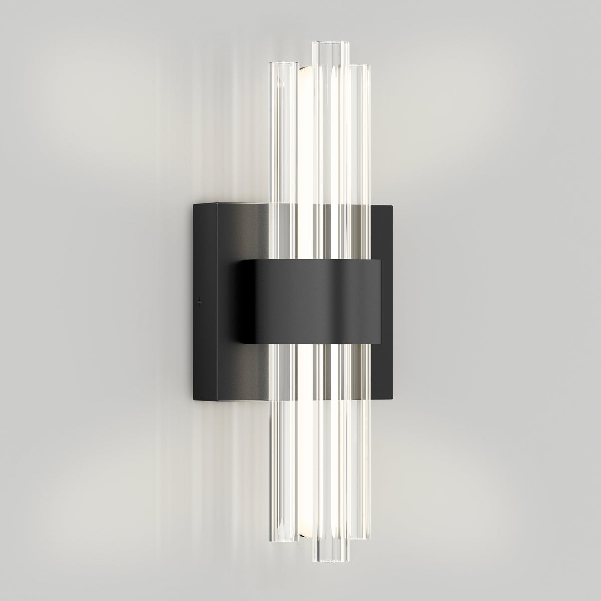 The Artika Dorado contemporary LED wall sconce features a sleek gold and black design with vertical glass rods, offering soft white light in three color temperatures for a modern, upscale look against a light gray wall.