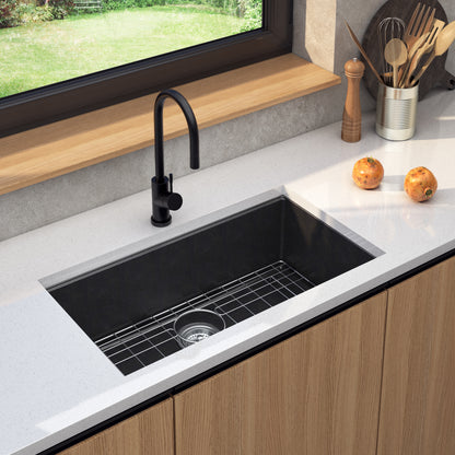 Artika Baycrest 31 in. Modern Sink with black faucet, onions on white countertop, and utensils by the window.