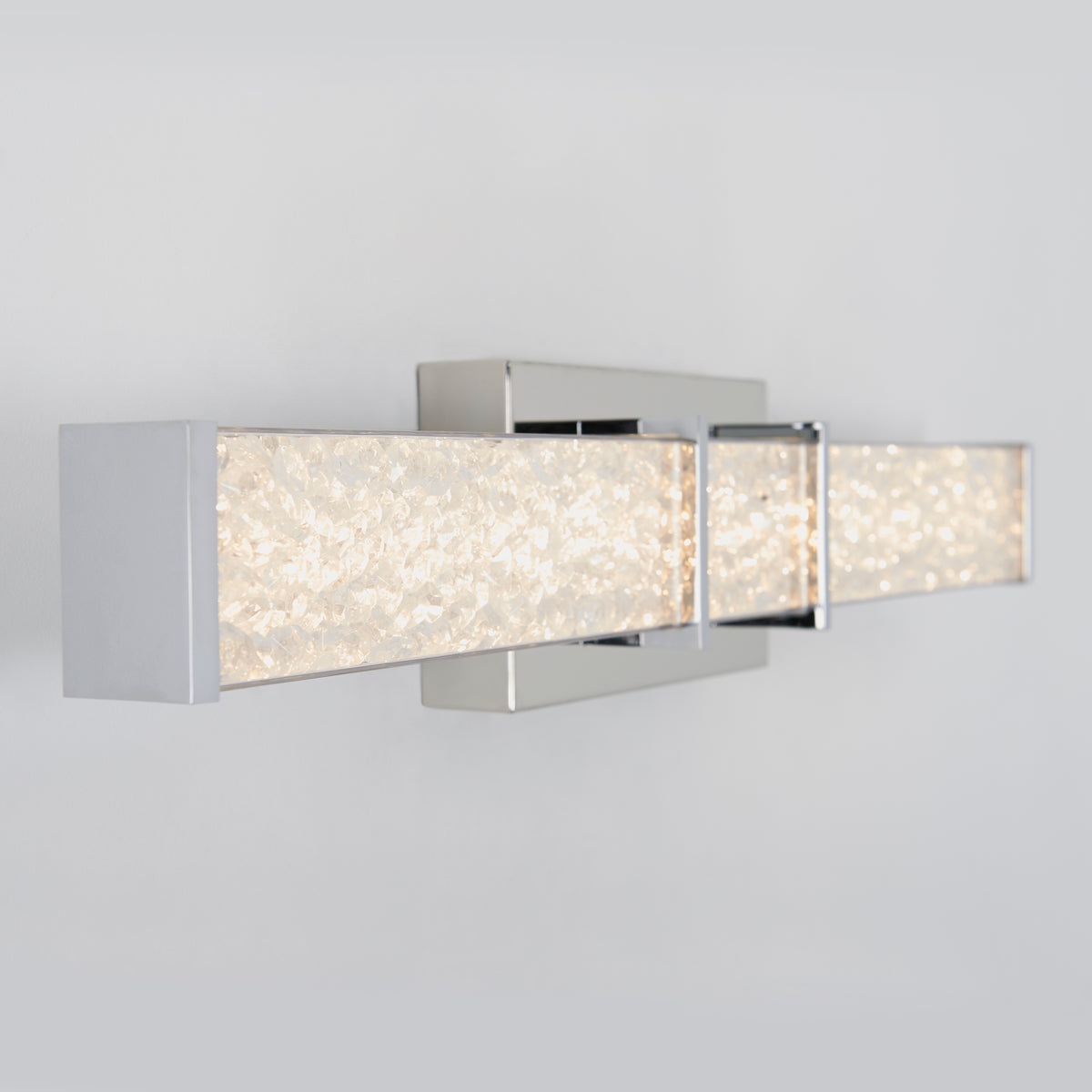 Artika Royale 27-in LED Vanity Light Bar with chrome finish and textured glass, mounted on a light gray bathroom wall.