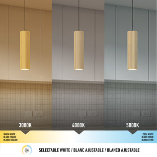 The Artika Groove LED modern pendant light 3 CCT is displayed above a kitchen island, showing its textured wood finish and three color temperatures—3000K, 4000K, and 5000K—each casting a unique ambiance.