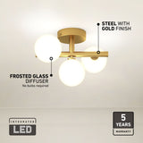 A modern ceiling light fixture with four frosted glass globes and a steel base in a gold finish. Labels highlight Frosted Glass Diffuser, Steel with Gold Finish, Integrated LED, and 5 Years Warranty.