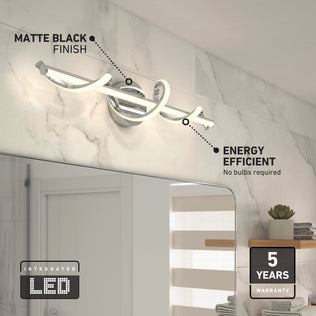 The Artika Coda modern LED bathroom vanity light 5 CCT in matte black, mounted above a mirror on a marble wall, is energy efficient with integrated LEDs, no bulbs required, and comes with a 5-year warranty.