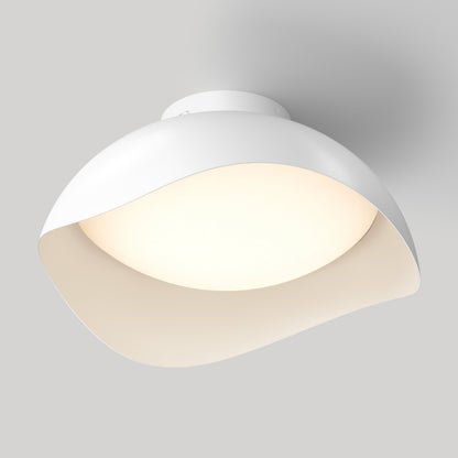 The Adara 15 in. (38 cm) Modern LED Flush Mount Ceiling Light 5 CCT is a white, dome-shaped light with a wavy, asymmetrical rim and glowing center.