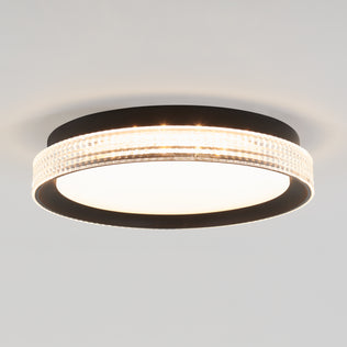 The Artika Aston 15 in. LED modern flush mount light features a round black frame, frosted white diffuser, and an illuminated textured edge band, stylishly mounted on a white ceiling.