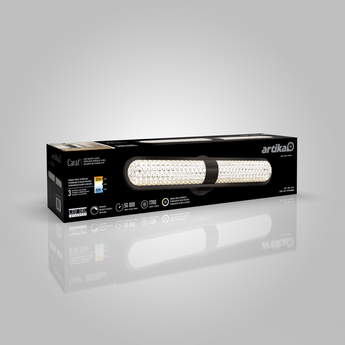 A black rectangular box with a picture of an LED vanity light on the front, labeled artika Carat, featuring gold and white accents and product information on the packaging.