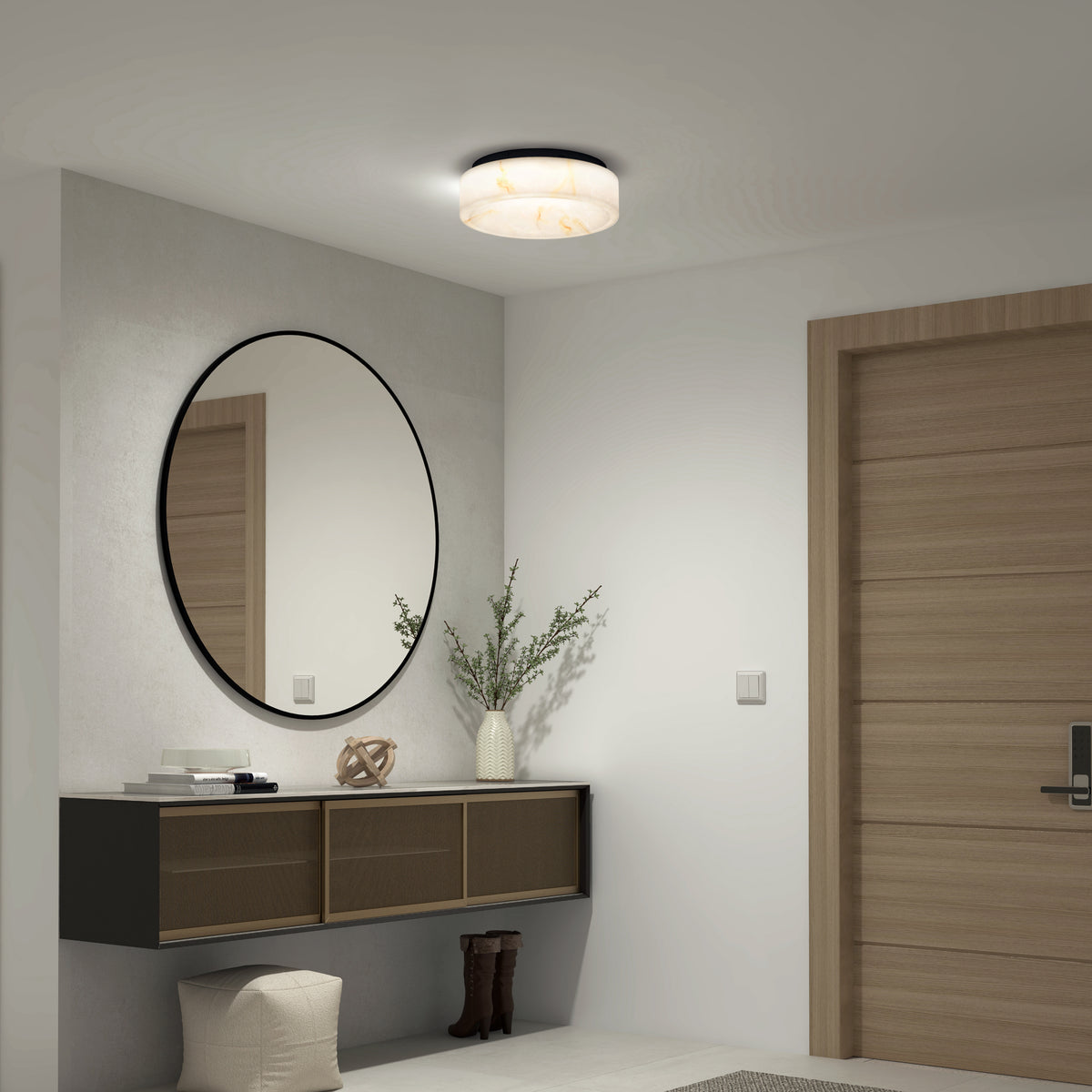 A modern hallway with a wooden door, a round wall mirror, a floating console table with a vase of branches, decorative objects, and a pair of boots. A round ceiling light illuminates the neutral-toned space.