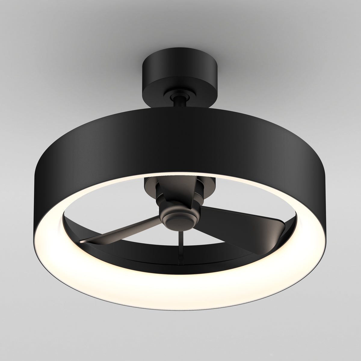 A modern ceiling fan with three black blades, enclosed in a circular black frame with an integrated LED light, mounted on a white ceiling.