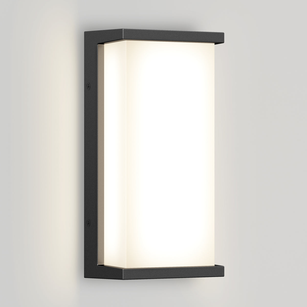 A modern rectangular wall sconce with a black metal frame and frosted white diffuser, mounted on a light gray wall, emitting a soft, even glow.
