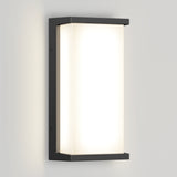 A modern rectangular wall sconce with a black metal frame and frosted white diffuser, mounted on a light gray wall, emitting a soft, even glow.