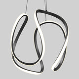 A modern, abstract pendant light featuring two looping, intertwined black bands with integrated white LED strips, suspended from the ceiling against a plain light gray background.