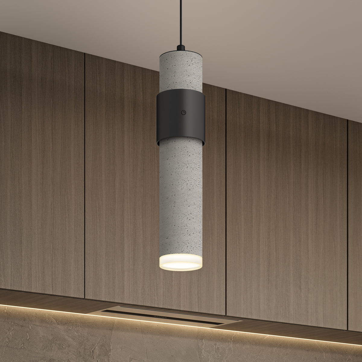 The Artika Barden 3-light LED pendant light features a modern cylindrical design with concrete texture and black accents, hanging in front of wood-paneled cabinets and casting a warm downward glow.