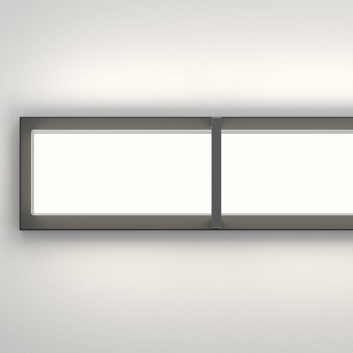 A modern rectangular wall light fixture with a black frame and a dividing vertical strip, mounted on a white wall and casting a soft glow.