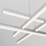 Minimalist white ceiling light fixture with four intersecting horizontal bars, suspended by thin cables against a neutral background. The design is geometric and modern.