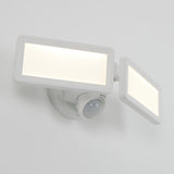 A white, wall-mounted LED security floodlight with two rectangular adjustable panels and a motion sensor beneath them, shown against a plain white background.