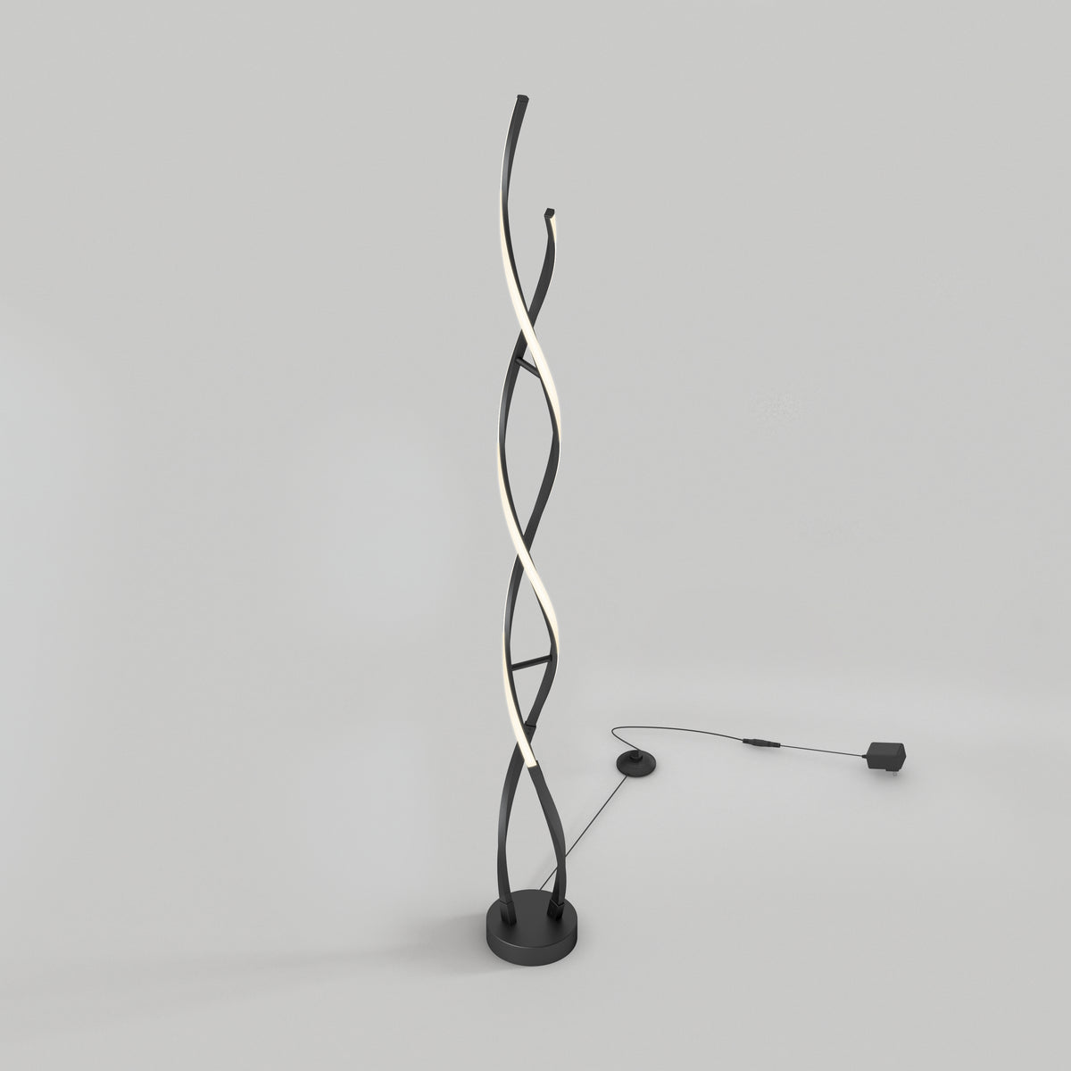 The Artika Swirl modern LED floor lamp features three intertwining rods—two black and one illuminated—on a round base with a visible power cord and adapter, displayed against a plain light gray background.