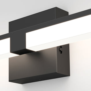 Close-up of the Artika Tivoli modern LED bathroom vanity light 5 CCT, a sleek rectangular black wall sconce with a horizontal white glowing bar and adjustable lighting, mounted on a plain white wall.