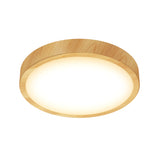 A round ceiling light with a wooden frame and a glowing white center, photographed against a white background.