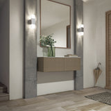 A modern entryway with a floating console, large mirror, green vase with leafy branches, wall sconces, tiled floor, woven rug, and a beige umbrella in a corner stand.