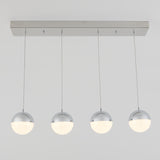 A modern ceiling light fixture with four suspended spherical lamps, each half chrome and half frosted white, hanging in a straight line from a rectangular metallic base.
