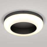 A modern, circular ceiling light fixture with a black center and a glowing white ring, mounted on a smooth, light gray ceiling.