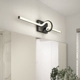 A modern wall-mounted LED light with a rectangular black base and a glowing tube that loops in a knot-like shape, installed above a bathroom mirror near a window with white blinds and a green plant.
