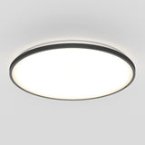 A round, modern ceiling light fixture with a black rim and a bright white illuminated center, mounted on a plain, light-colored ceiling.