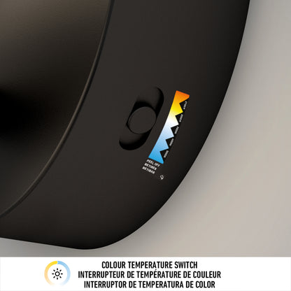 Close-up of the Artika Chorus LED Wall Light in black, featuring a color temperature switch with sliding button and scale from warm to cool. Below, “COLOUR TEMPERATURE SWITCH” appears in English and two other languages.