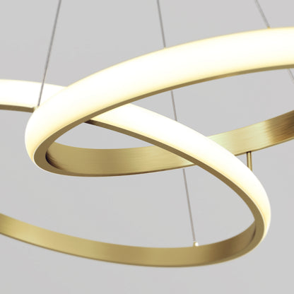 Artika’s Mora 28″ LED Pendant features dimmable, intertwined gold rings as a modern chandelier against a light background.
