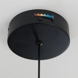 A black circular ceiling fixture with a single cord hanging down and a small label featuring colored triangles and text on the side.